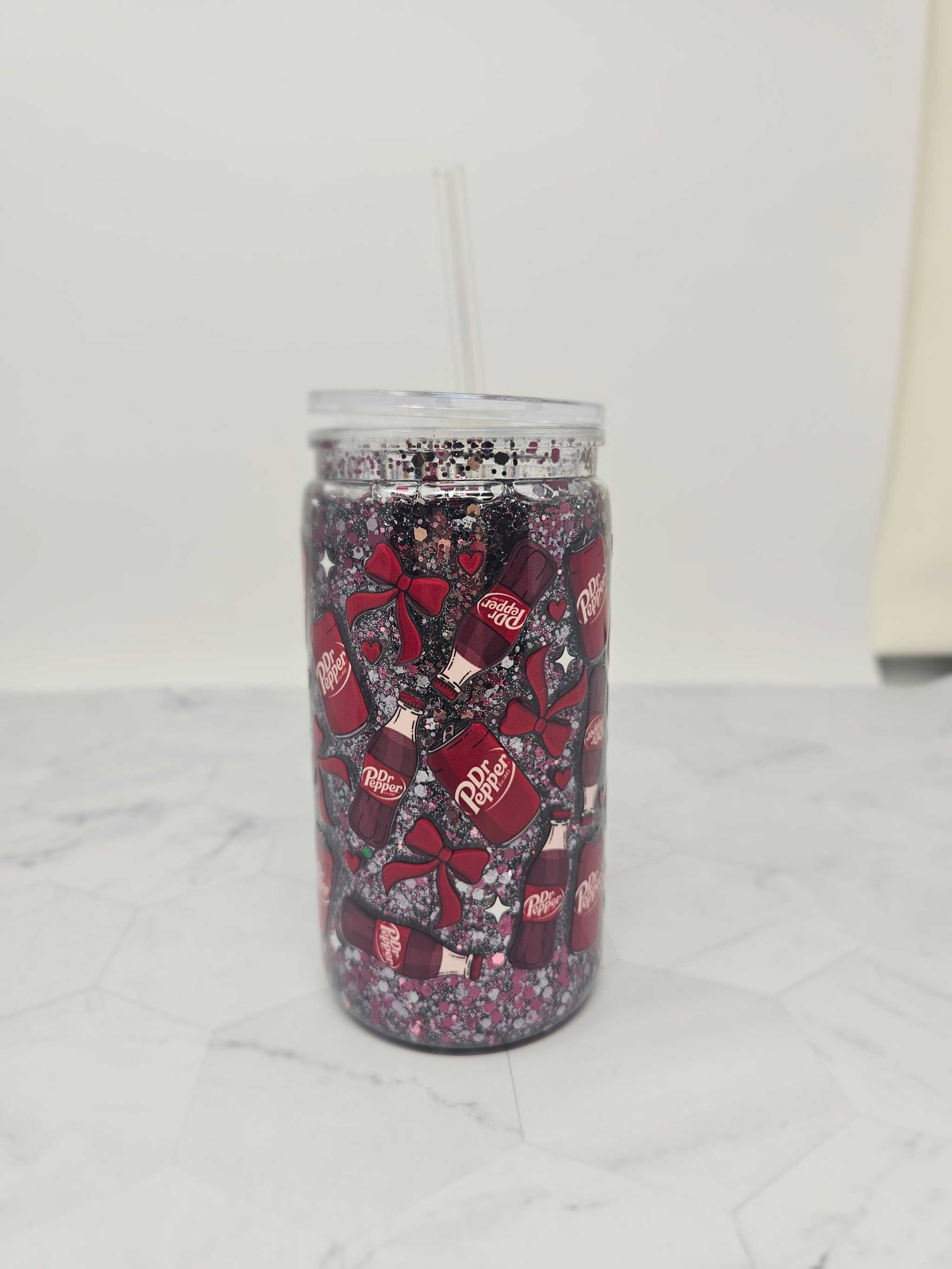 16 oz acrylic snow globe tumbler with Dr. Pepper glitter and decorative bows