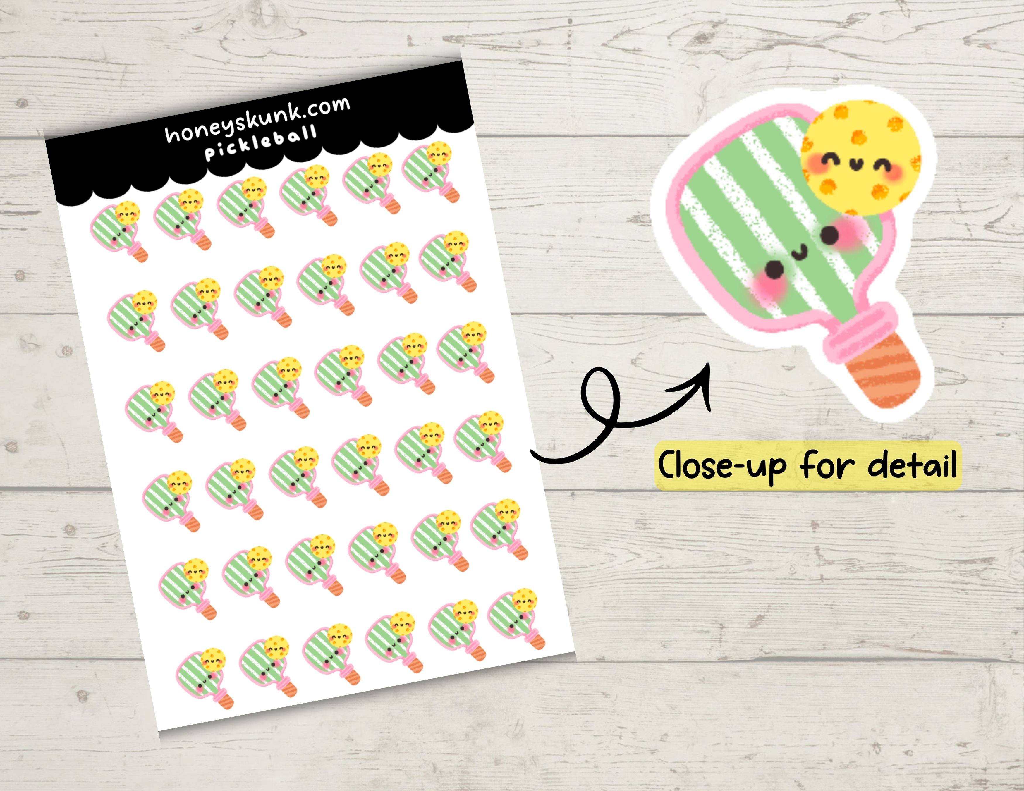 Sheet of pickleball-themed stickers with a close-up of a kawaii-style pickleball paddle on a wooden surface.