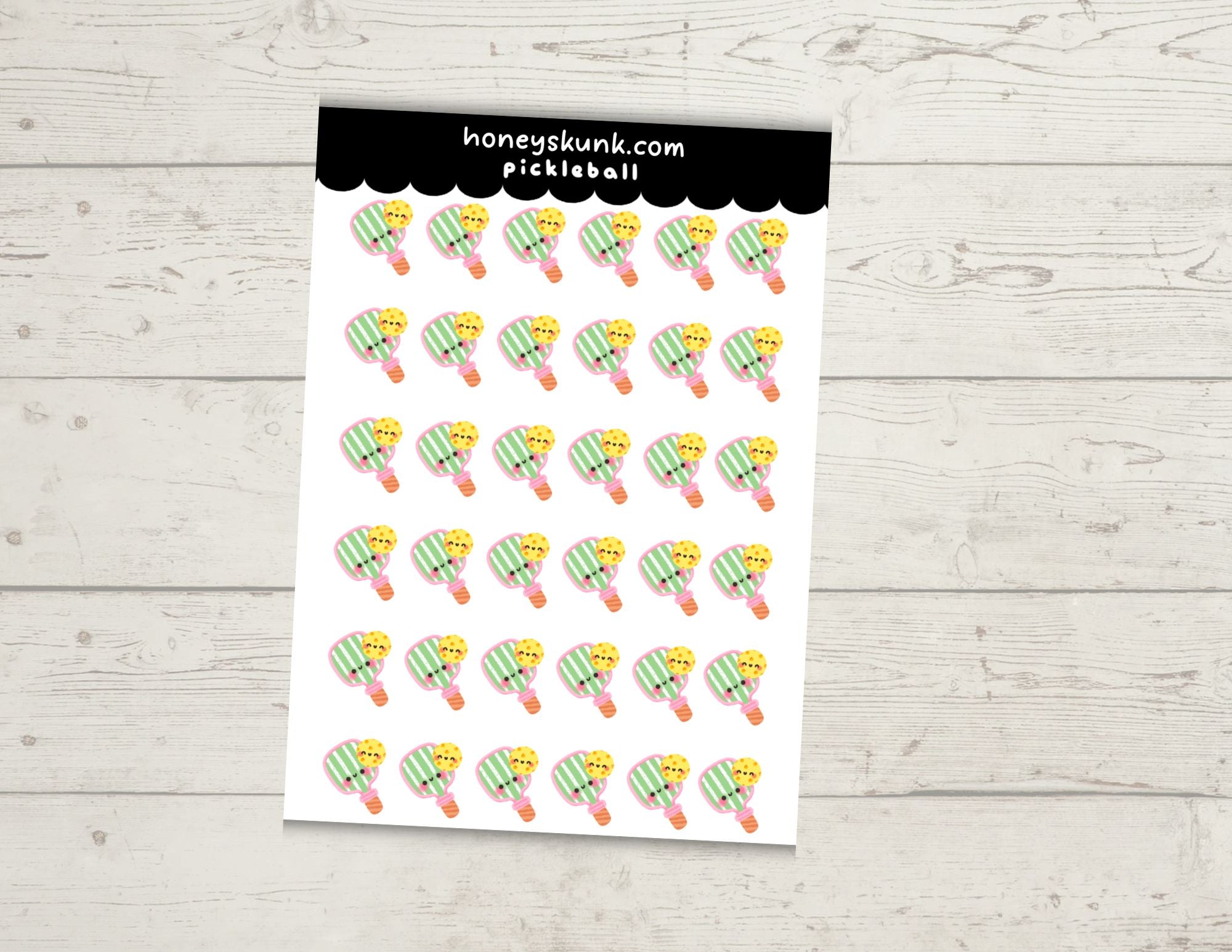 Sheet of pickleball-themed stickers with 'honeykunk.com' branding on a light wooden surface.