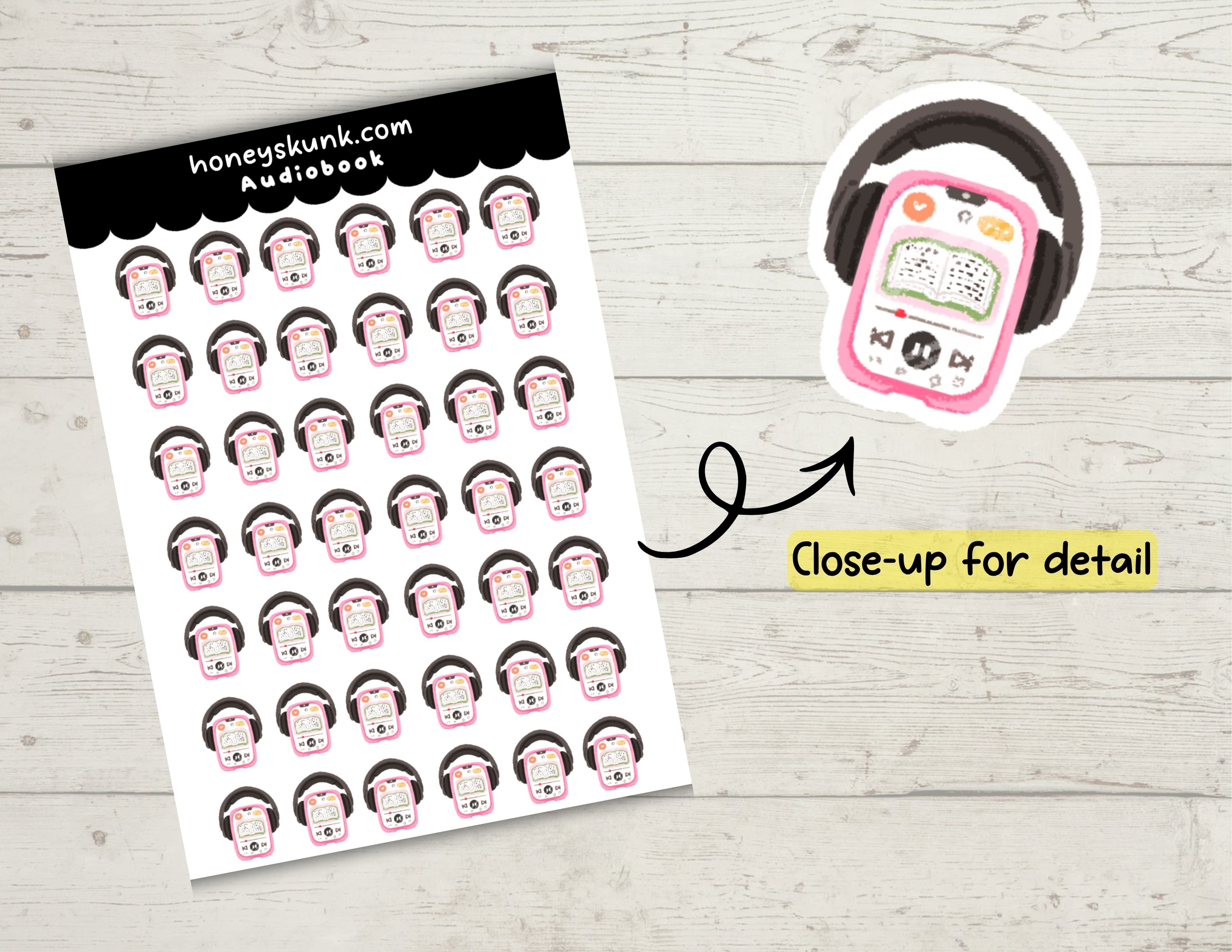 Sheet of planner stickers with character faces and a close-up of an audiobook player on a wooden surface.