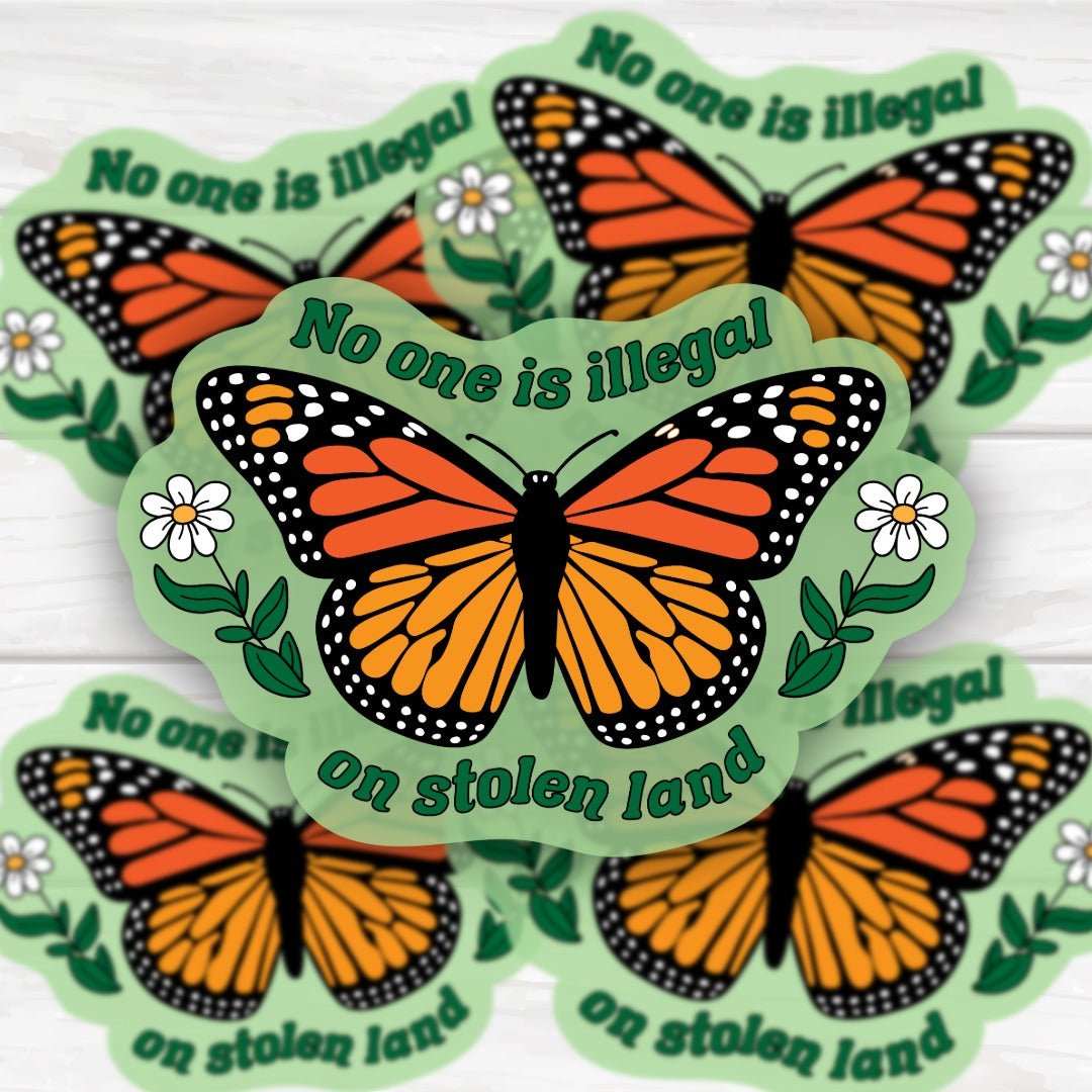 Monarch butterfly sticker with "No One Is Illegal On Stolen Land" message and vibrant design