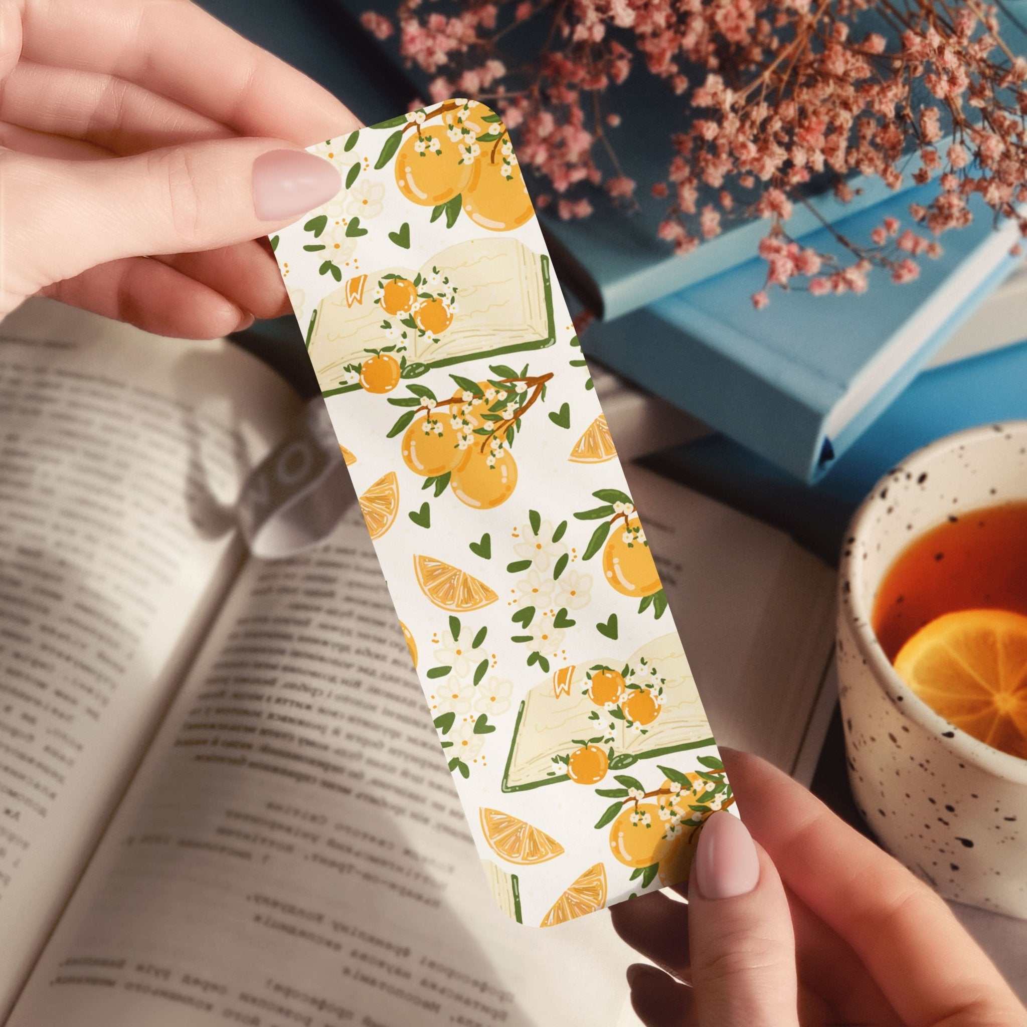 Bookmark with delicate books, hand-drawn oranges, and orange blossoms in warm cottagecore style