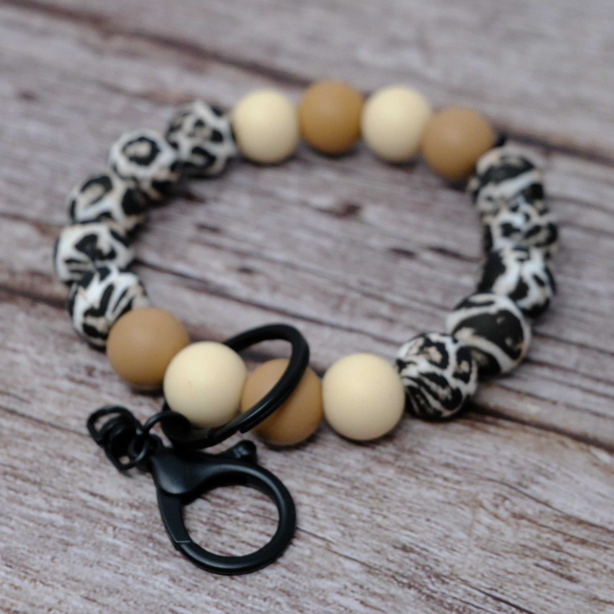 Leopard print wristlet keychain with tan and cream silicone beads and black lobster clasp