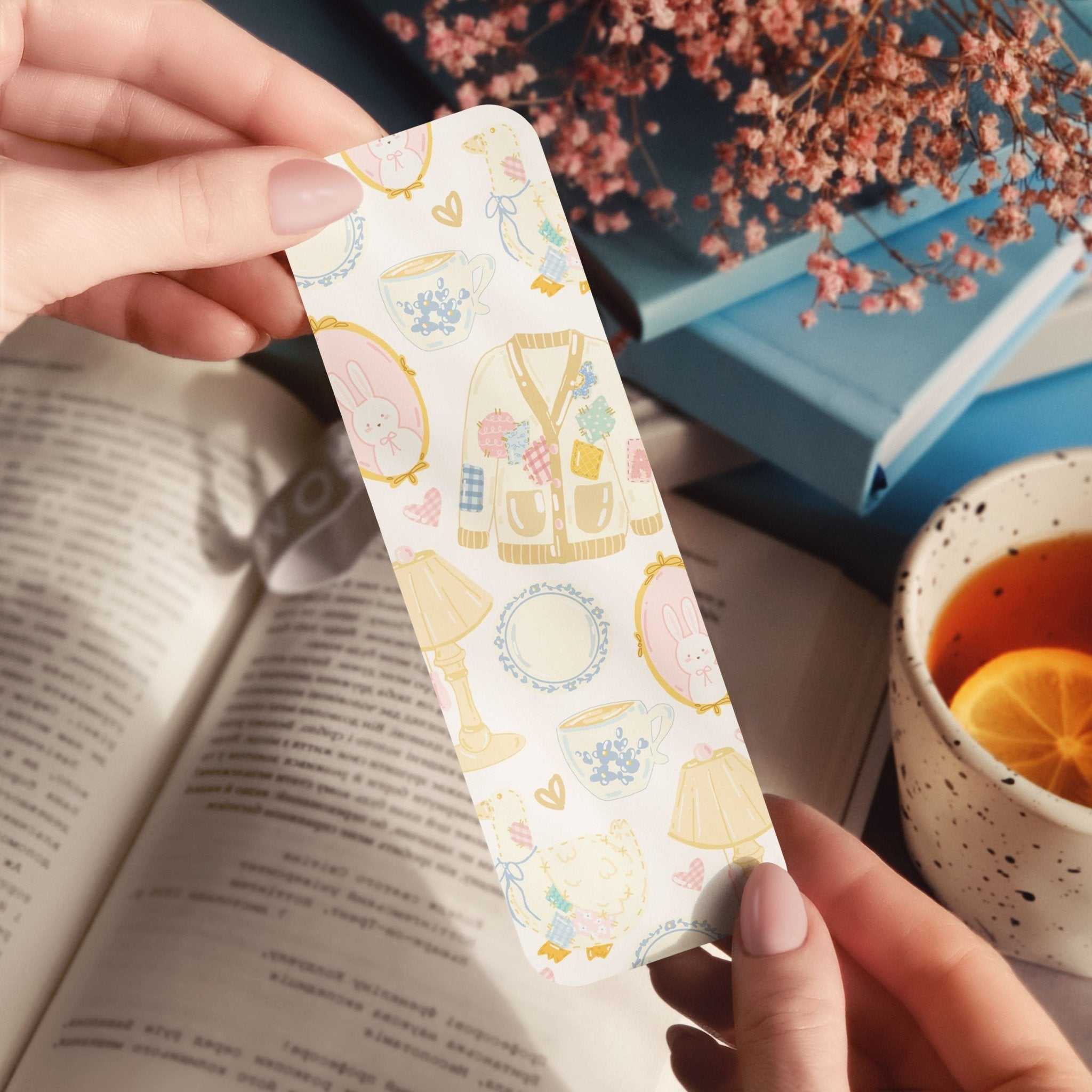 Bookmark featuring spring sweaters, bunnies, tea cups, and wildflowers with cozy cottage core design